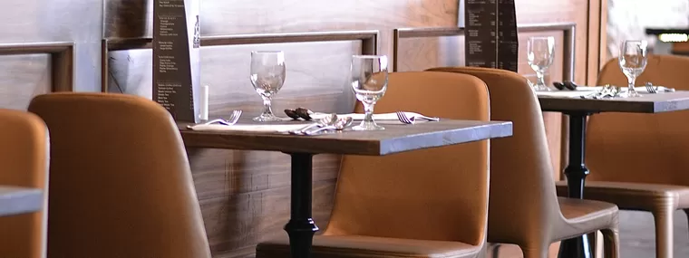 Empty tables set for service in a quiet dining room